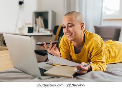 Young Bald Woman Doing Homework In Her Room