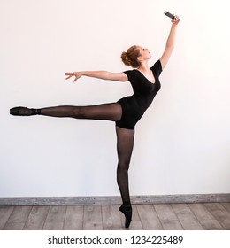 Young Balerina Make Selfie In Training Room. She Is Posing At Camera In Her Smartphone.