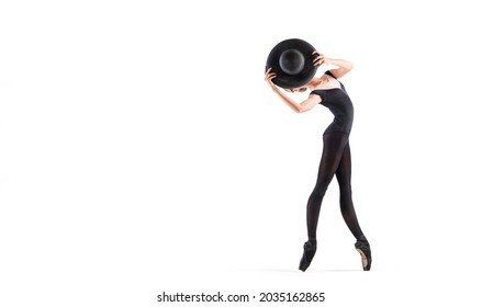 Young Ballerina In Black Pointe Shoes And An Elegant Hat Posing On A White Background