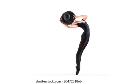 Young Ballerina In Black Pointe Shoes And An Elegant Hat Posing On A White Background