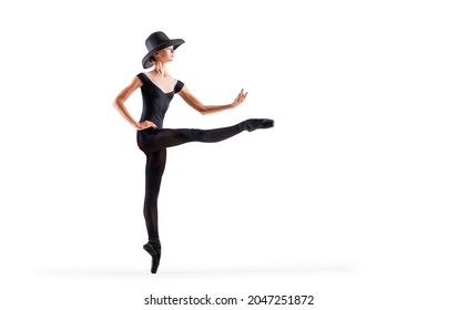 Young Ballerina In Black Pointe Shoes And An Elegant Hat Posing On A White Background