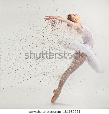 Young ballerina dancer in tutu performing on pointes 