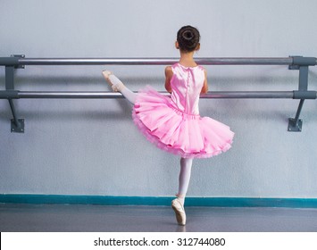 Young Ballerina In A Pink Ballet Tutu Is Dancing In Dance Class