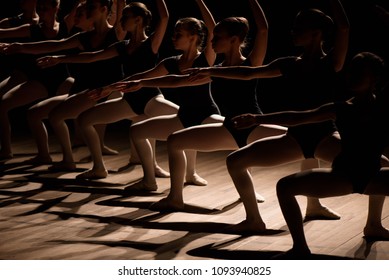 Young Ballerinas Practicing A Choreographed Dance All Raining Their Arms In Graceful Unison During Practice At A Ballet School