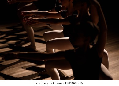 Young Ballerinas Practicing A Choreographed Dance All Raining Their Arms In Graceful Unison During Practice At A Ballet School