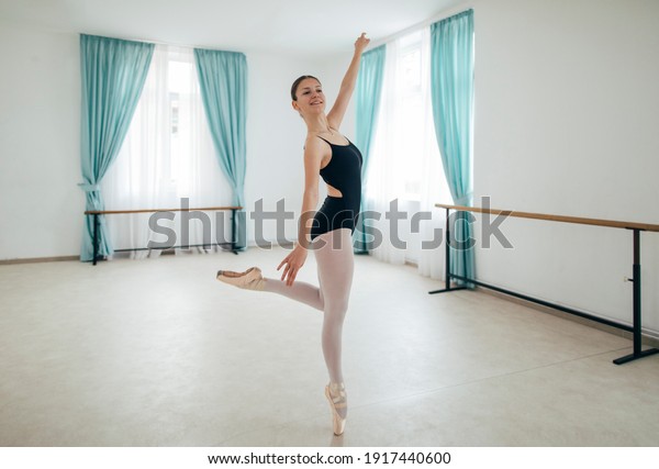 Young ballet dancer\
posing in ballet studio