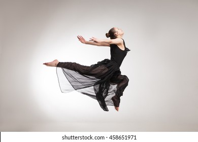 Young Ballet Dancer Wearing Black Transparent Dress Jumping 