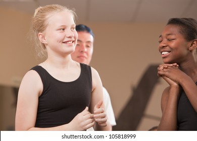 Young Ballet Students Laughing Together At Dance Class