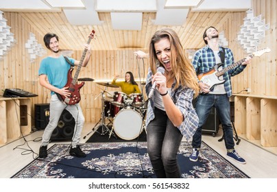 Young Band Music Recording In A Studio.