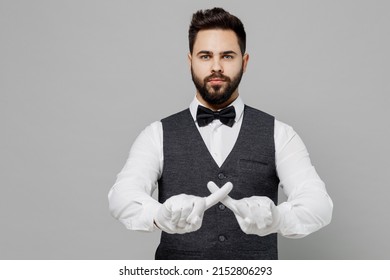 Young Barista Male Waiter Butler Man 20s Wear White Shirt Vest Elegant Uniform Work At Cafe Hold Index Finger Crossed Isolated On Plain Grey Background Studio Portrait. Restaurant Employee Concept.