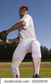 Young baseball pitcher winding up to throw the baseball