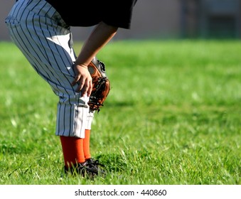 Young baseball player in outfield; space for copy.