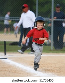 Young Baseball Player Running And Smiling During Game