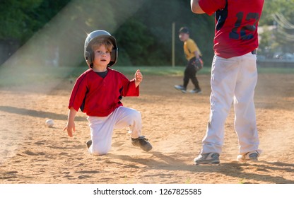 Young Baseball Player Sliding Into Home Plate