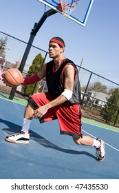 A Young Basketball Player Demonstrating His Crossover Dribble And Ball Handling Abilities.