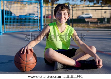 Similar – Teenage boy holding a basketball on a court