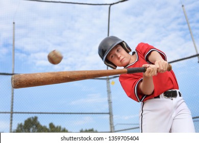 Young Batter Hitting The Ball In A Youth Baseball Game