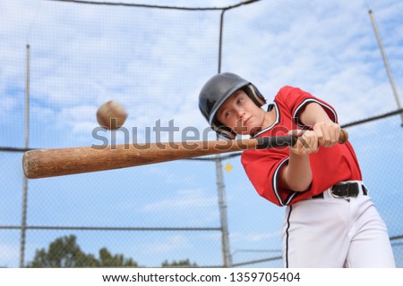 Young batter hitting the ball in a youth Baseball game