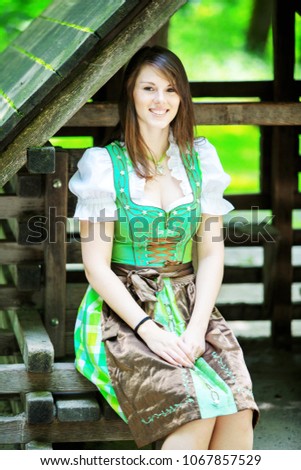 Similar – Foto Bild Frau im Dirndl im bayerischen Biergarten sitzend und Bier trinkend mit traditioneller bayerischer Küche mit Schweinshaxe, gebratener Schweinshaxe auf einem Tisch