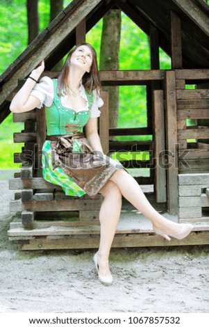 Similar – Foto Bild Frau im Dirndl im bayerischen Biergarten sitzend und Bier trinkend mit traditioneller bayerischer Küche mit Schweinshaxe, gebratener Schweinshaxe auf einem Tisch