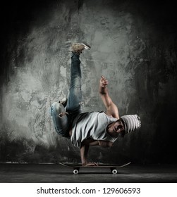 Young B-boy Man Doing Brake Dancing Movements On Skateboard