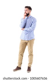 Young Bearded Adult Business Man In Formalwear Thinking And Looking Up With Hand On Chin. Full Body Length Portrait Isolated On White Background.