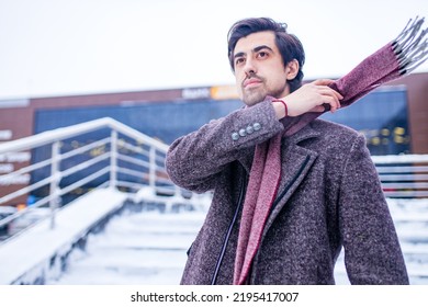 Young Bearded Arabian Man With Modern Hairstyle In Coat Wit Wool Scarf