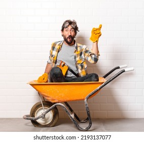 young bearded construction worker man on a wheelbarrow - Powered by Shutterstock