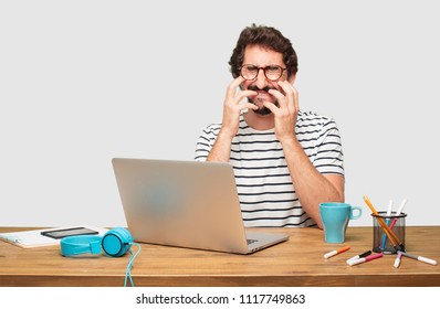 young bearded graphic designer with a laptop  - Powered by Shutterstock