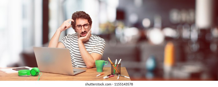 Young Bearded Graphic Designer With A Laptop With A Goofy, Dumb, Silly Look, Feeling Shocked And Confused At A Recent Realization, Not Really Understanding An Idea.