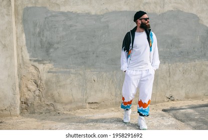 Young Bearded Hipster Guy Wearing A Vintage Tracksuit And White Blank T-shirt. Mock-up For Print. T-shirt Template.