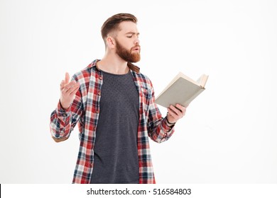 Young bearded man actor reading script over white background