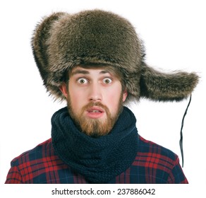 Young Bearded Man In The Earflaps Hat Looks Silly, Isolated On A White Background.