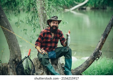 Young Bearded Man Fishing At A Lake Or River. Flyfishing.