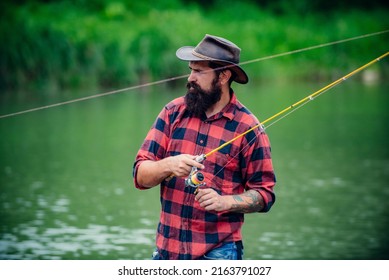 Young Bearded Man Fishing At A Lake Or River. Flyfishing.