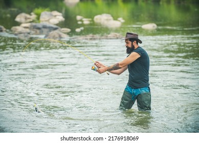 Young Bearded Man Fishing At A Lake Or River. Flyfishing.