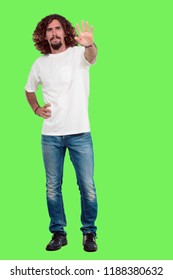 young bearded man full body gesturing  against chroma key green background. ready to cut out