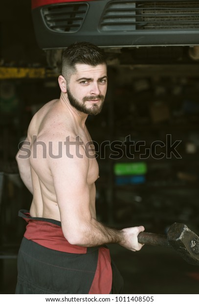 young bearded man with a\
hammer