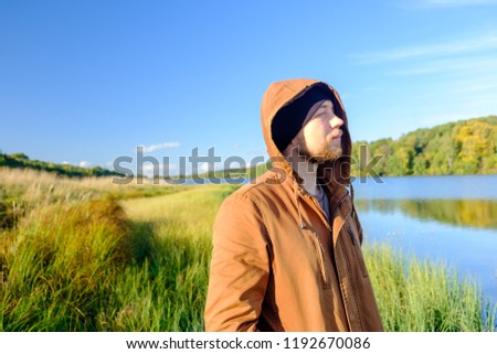 Similar – Entspannter Mann genießt die Natur an einem ruhigen See