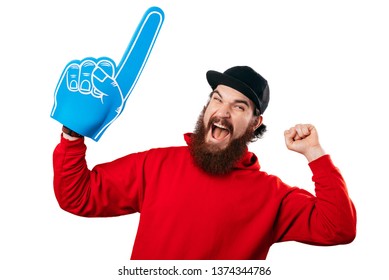 Young bearded man having an exciting face with foam blue number one hand glove on white background. - Powered by Shutterstock