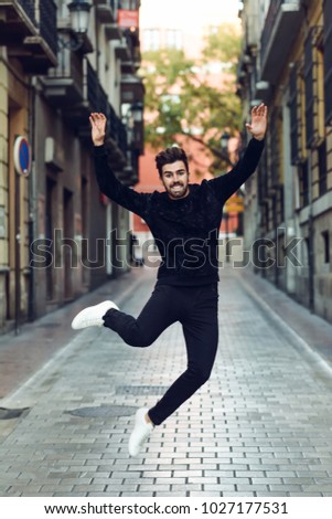 Similar – Young bearded man jumping in urban street