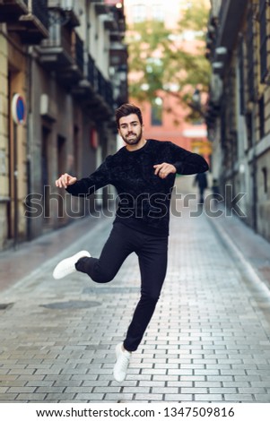 Similar – Young bearded man jumping in urban street