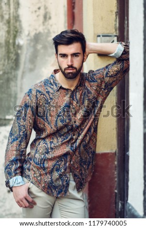 Similar – Thoughtful young man sitting on an urban bench