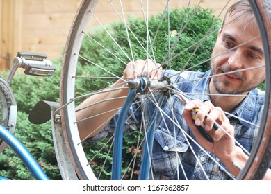 Young bearded man repair old vintage bicycle outdoor.  - Shutterstock ID 1167362857