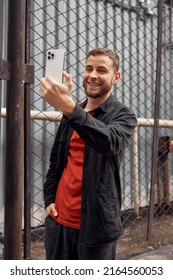 Young Bearded Man Taking Photo Selfie, Video Chat In The Street