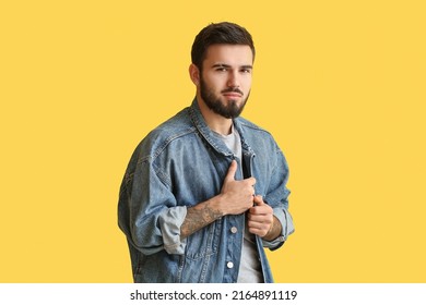 Young Bearded Man Wearing Denim Jacket On Yellow Background