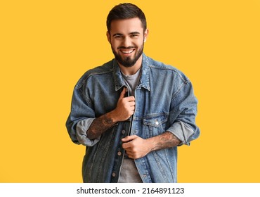 Young Bearded Man Wearing Denim Jacket On Yellow Background