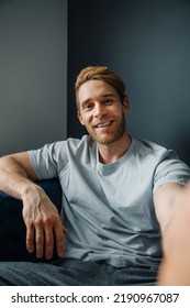 Young Bearded Man Wearing T-shirt Smiling While Taking Selfie Photo At Home