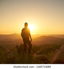 Young Bearded Millennial Man Hiking On Top Of Hill In California Over Looking San Diego At Sunset