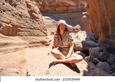 Young beauitufl hiker woman trekking natural orange mountain on summer holidays - Shutterstock ID 1519539449